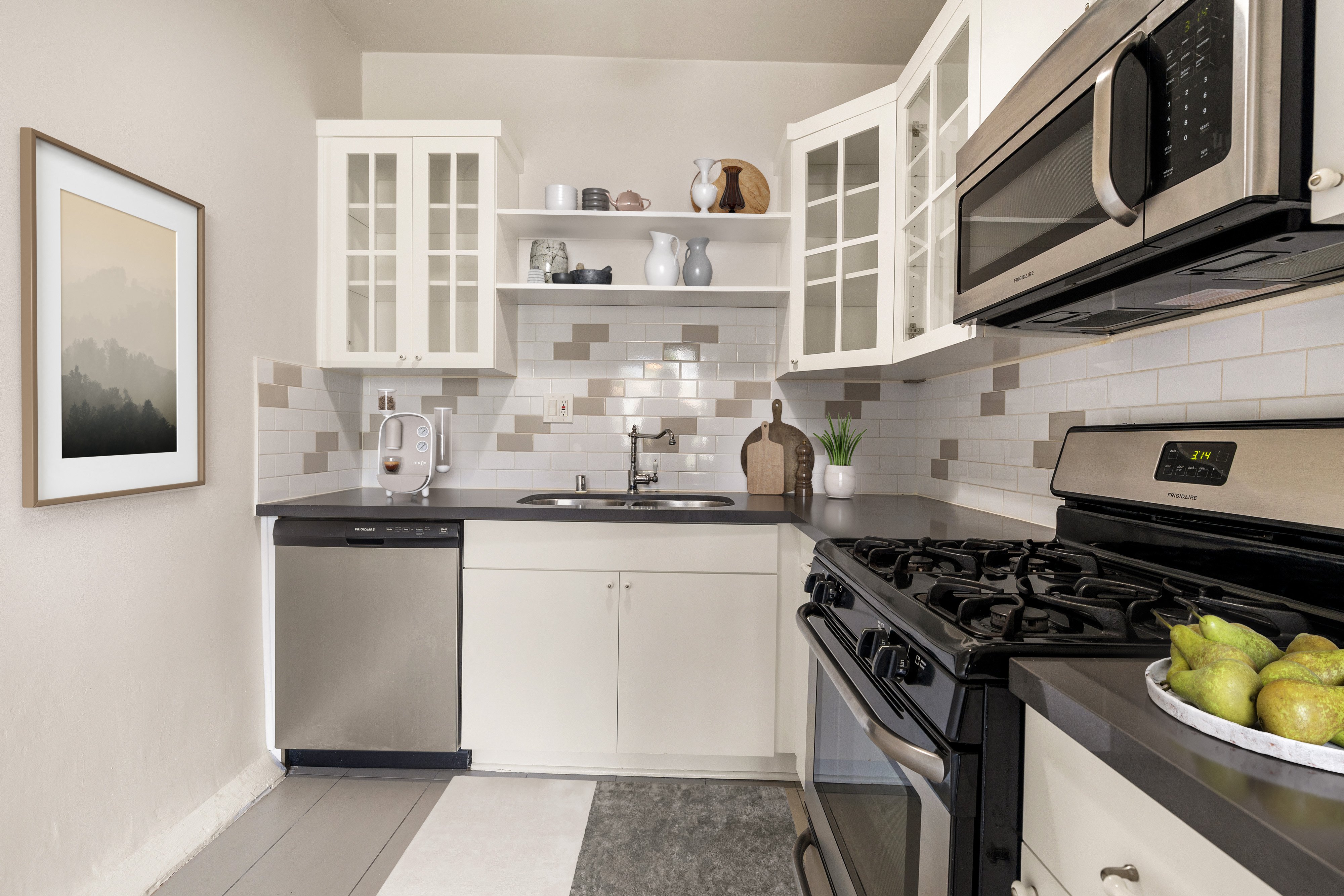 a kitchen with stainless steel appliances and white cabinets at Del Mor Apartments, Los Angeles, CA, 90026